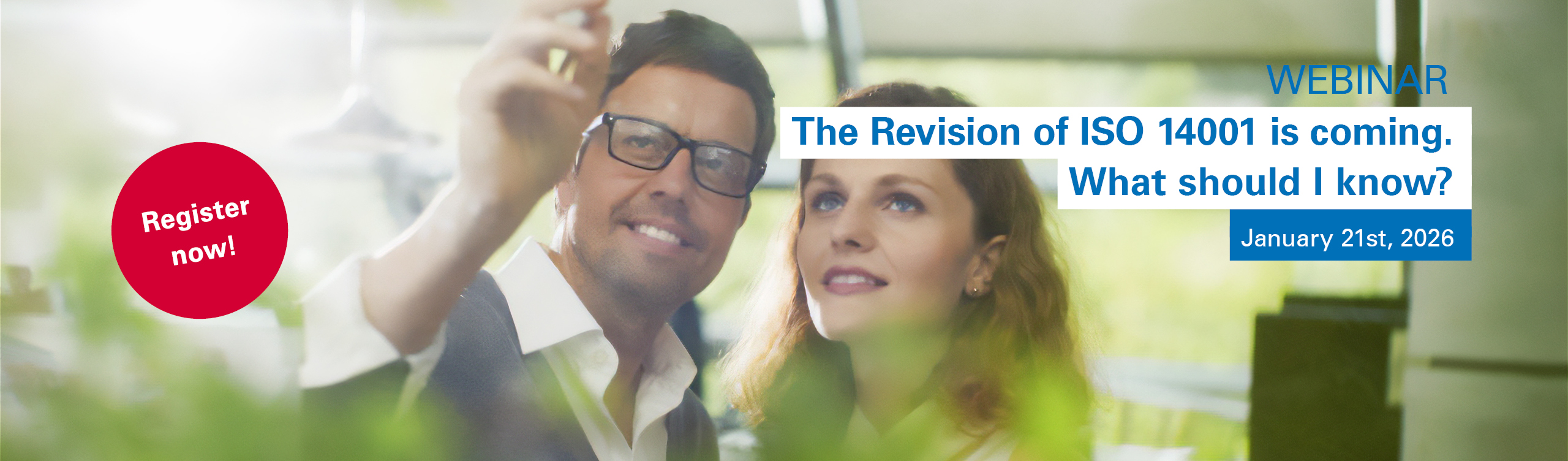 A man and a woman are reviewing the upcoming changes to ISO 14001 planned for 2026.