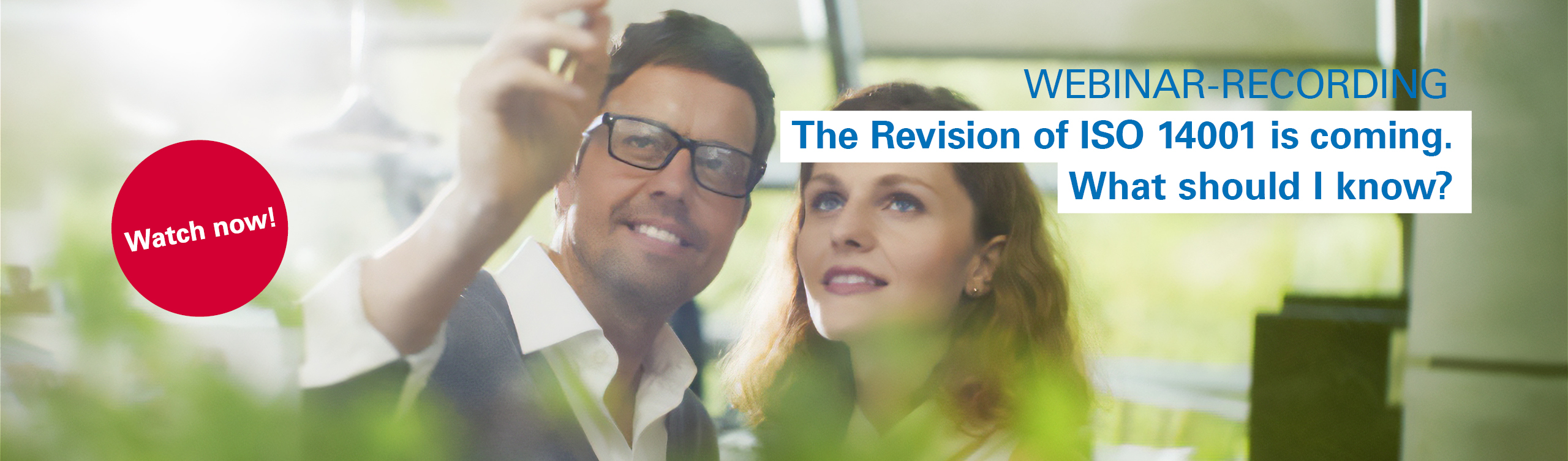 A man and a woman are reviewing the upcoming changes to ISO 14001 planned for 2026.